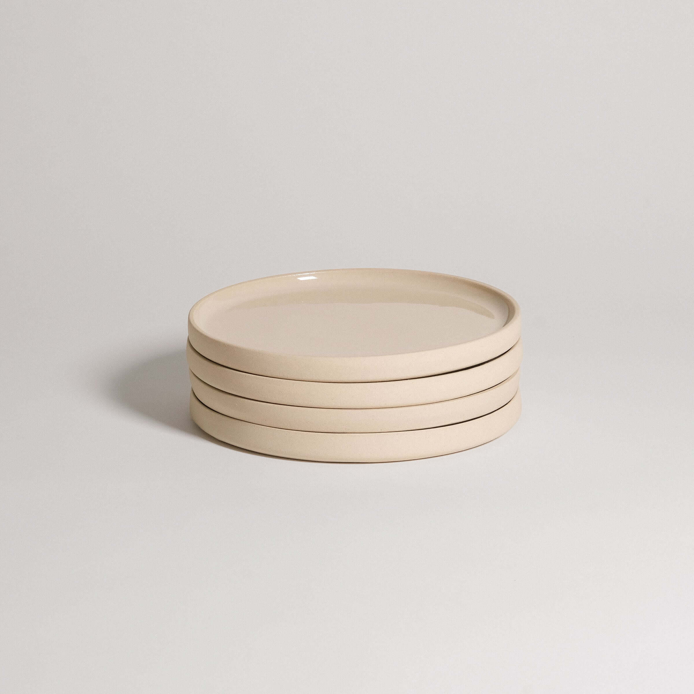 Set of 4 handcrafted breakfast plates in creme, made from durable stoneware ceramic with a transparent glaze.