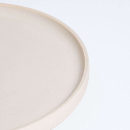 Close-up of a handcrafted creme breakfast plate made from durable stoneware ceramic.