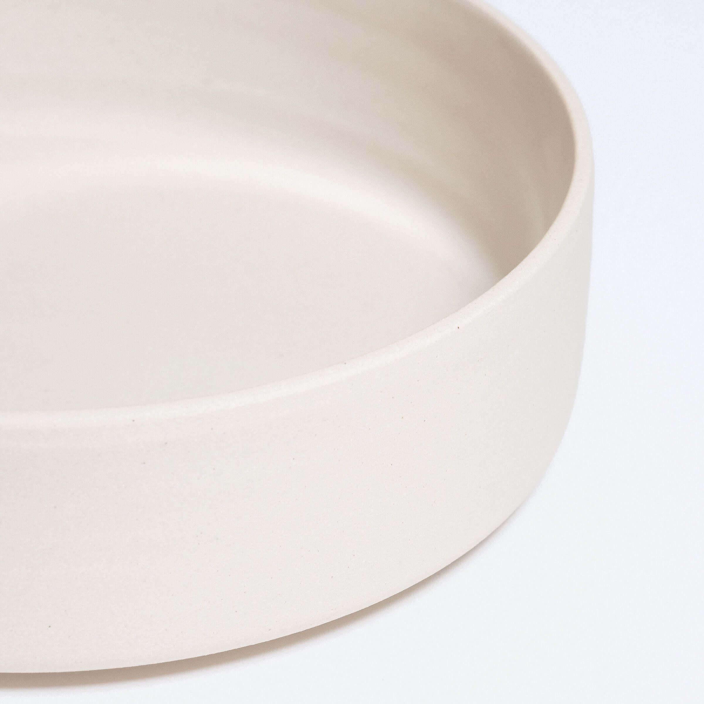 Set of 4 Nomi Creme Pasta Bowls made of grey stoneware clay with a glossy inner glaze and raw outer finish.