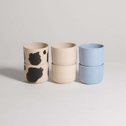 Mix & Match - Cup & Mug Bundle featuring stacked cups in black and blue glazes for personalized styles.